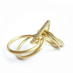 contemporary yellow gold and diamond 4 band stacking rings with a brushed finish. Multi band ring or interlocking ring.