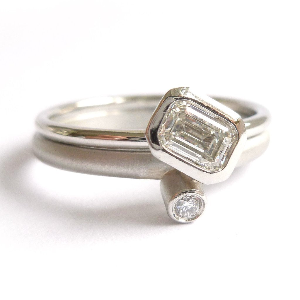 modern platinum and emerald cut diamond engagement and wedding ring