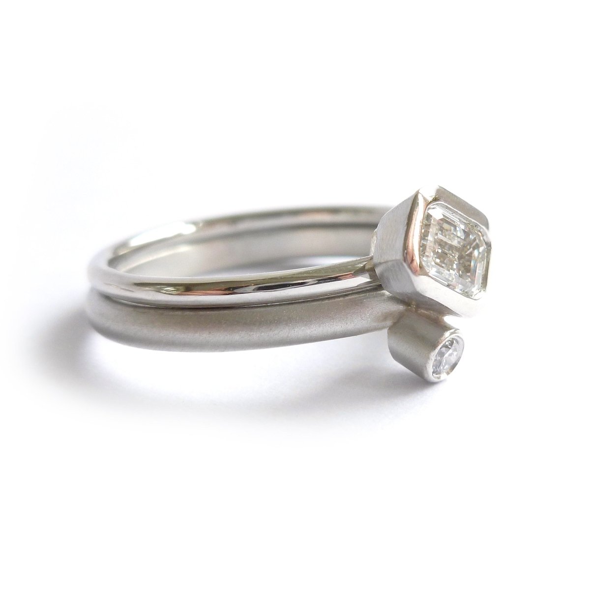 stacking modern platinum and emerald cut diamond engagement and wedding ring