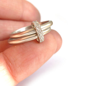Contemporary two band platinum stacking ring with pave set diamonds. Multi band ring or interlocking ring, sometimes called double band ring too.