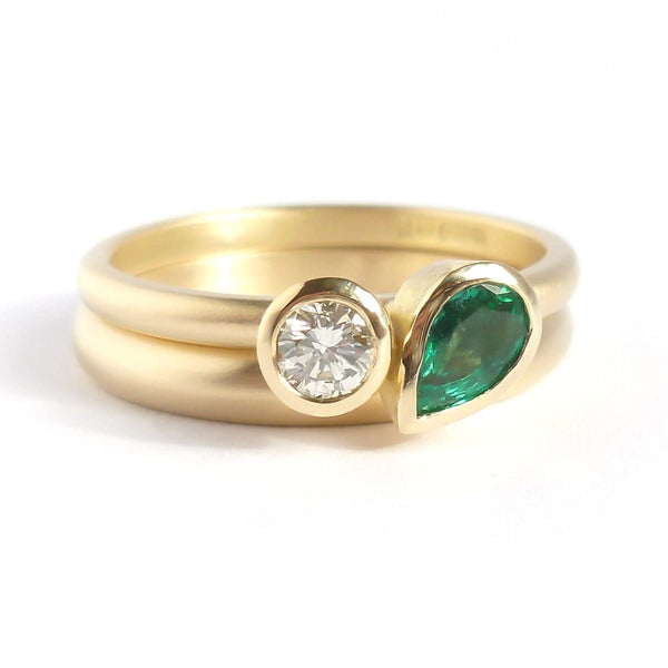 Pear shape emerald and diamond ring contemporary unique and modern.