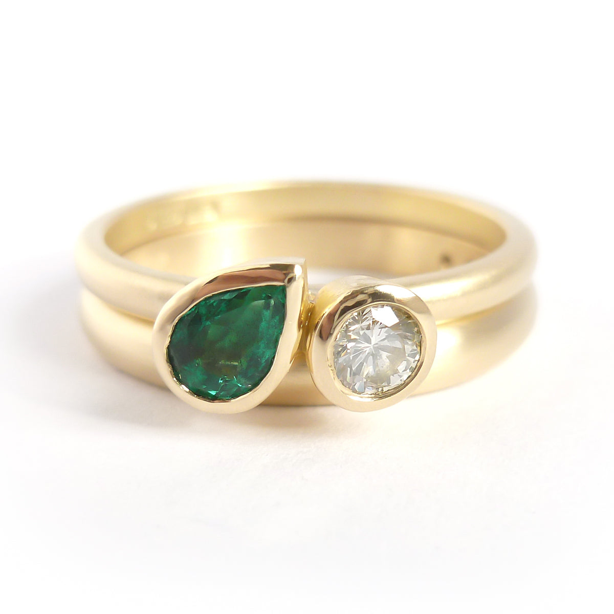 Pear shape emerald and diamond ring contemporary unique and modern.