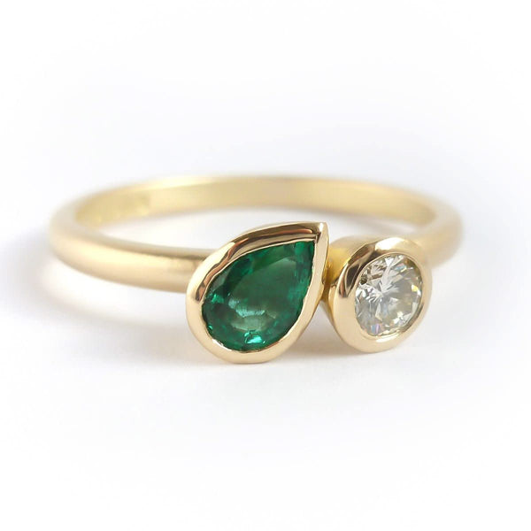 Pear shape emerald and diamond ring contemporary unique and modern.