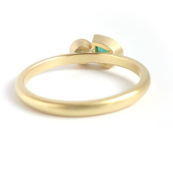 Pear shape emerald and diamond ring contemporary unique and modern.
