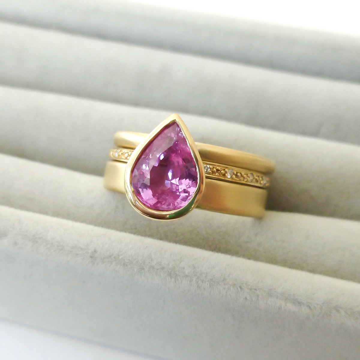 Pink pear shape sapphire and diamond stacking interlocking treble band 18ct yellow gold contemporary ringset ring