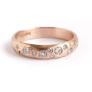 A modern unique rose gold eternity ring with 14 diamonds. Beautiful contemporary eternity ring, perfect for everyday wear.