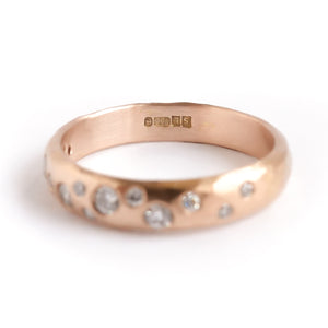 A modern unique rose gold eternity ring with 14 diamonds. Beautiful contemporary eternity ring, perfect for everyday wear.