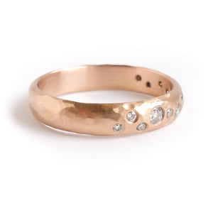 A modern unique rose gold eternity ring with 14 diamonds. Beautiful contemporary eternity ring, perfect for everyday wear.