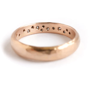 A modern unique rose gold eternity ring with 14 diamonds. Beautiful contemporary eternity ring, perfect for everyday wear.