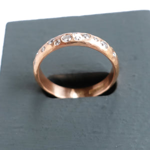 A modern unique rose gold eternity ring with 14 diamonds. Beautiful contemporary eternity ring, perfect for everyday wear.