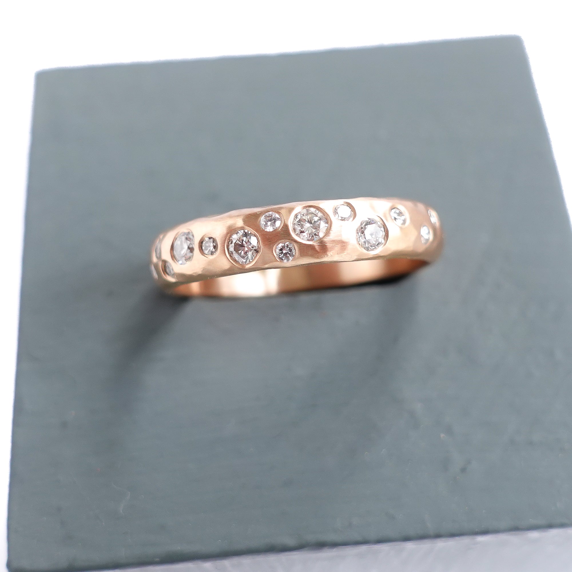 A modern unique rose gold eternity ring with 14 diamonds. Beautiful contemporary eternity ring, perfect for everyday wear.