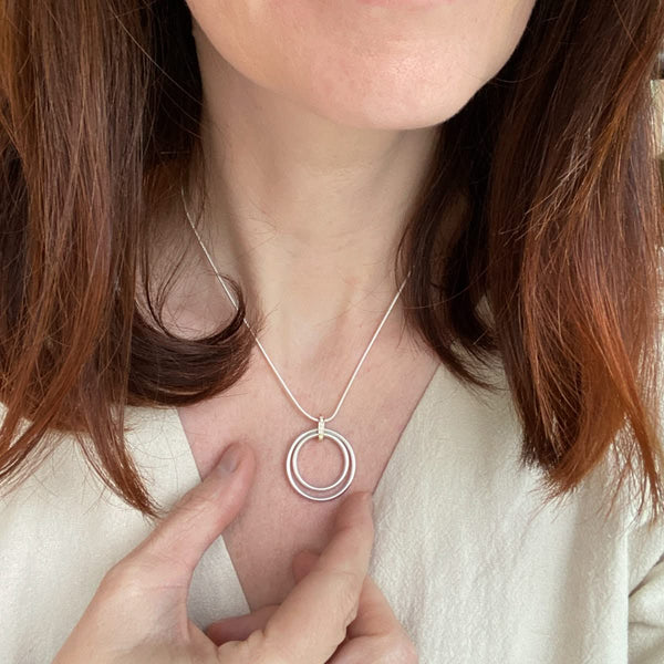 Model wearing the 28mm Sue Lane pavé diamond and silver necklace on a snake chain.