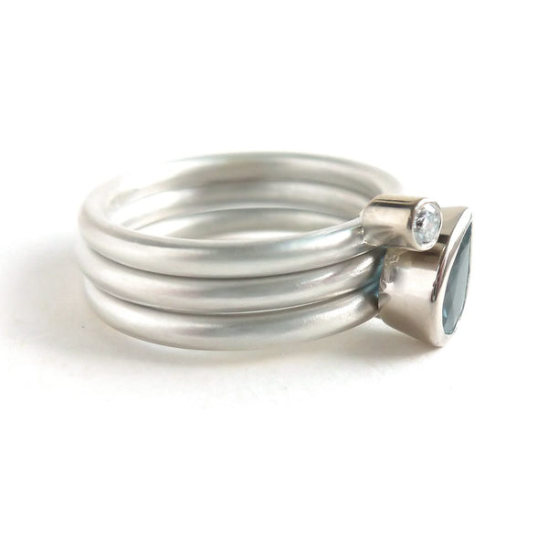 A unique, contemporary aquamarine and diamond gold and silver ring