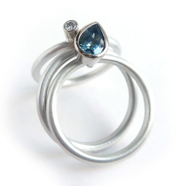 A unique, contemporary aquamarine and diamond gold and silver ring
