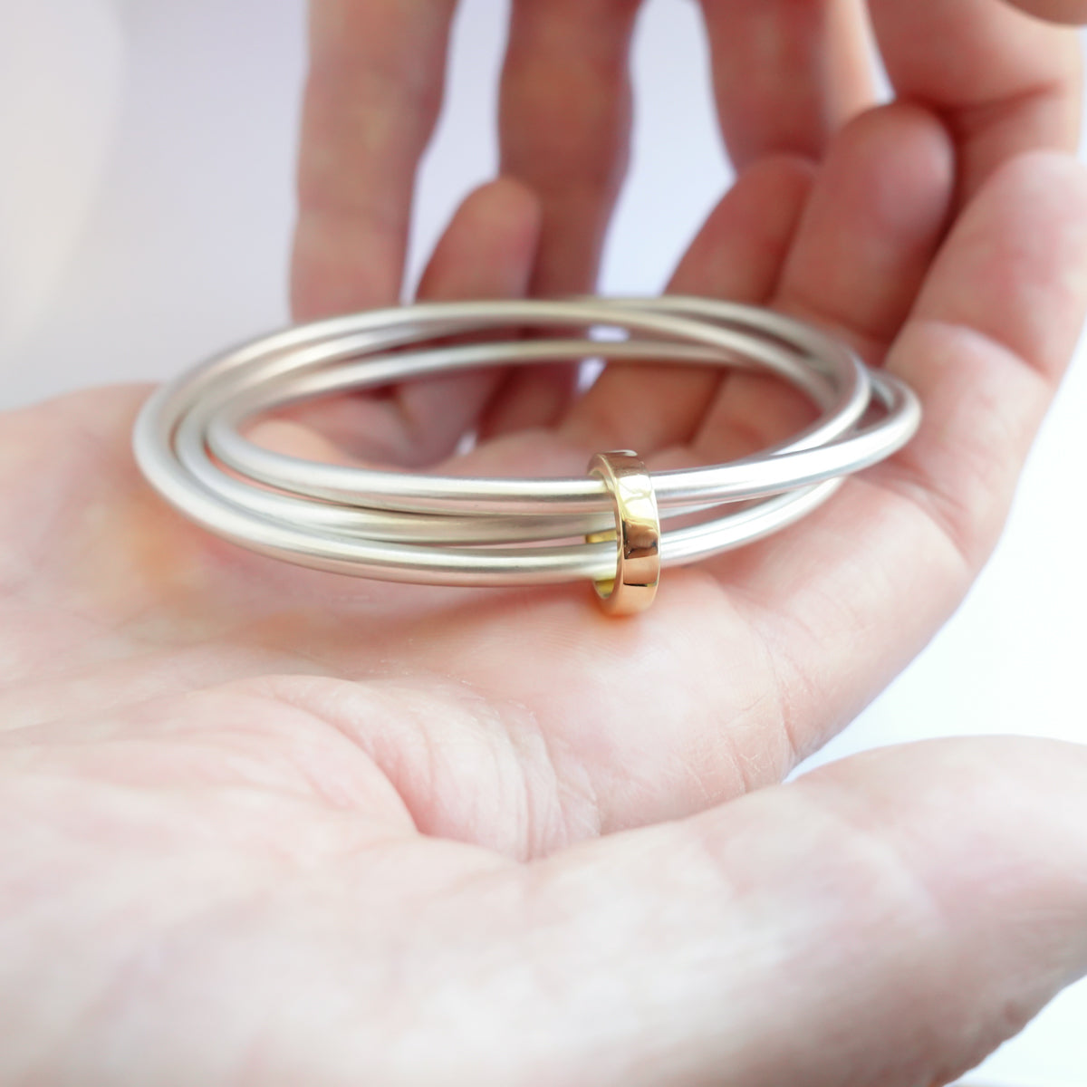Unusual, unique, bespoke and modern silver and gold Russian style bangle with brushed finish. Handmade by Sue Lane Jewellery in Herefordshire, UK
