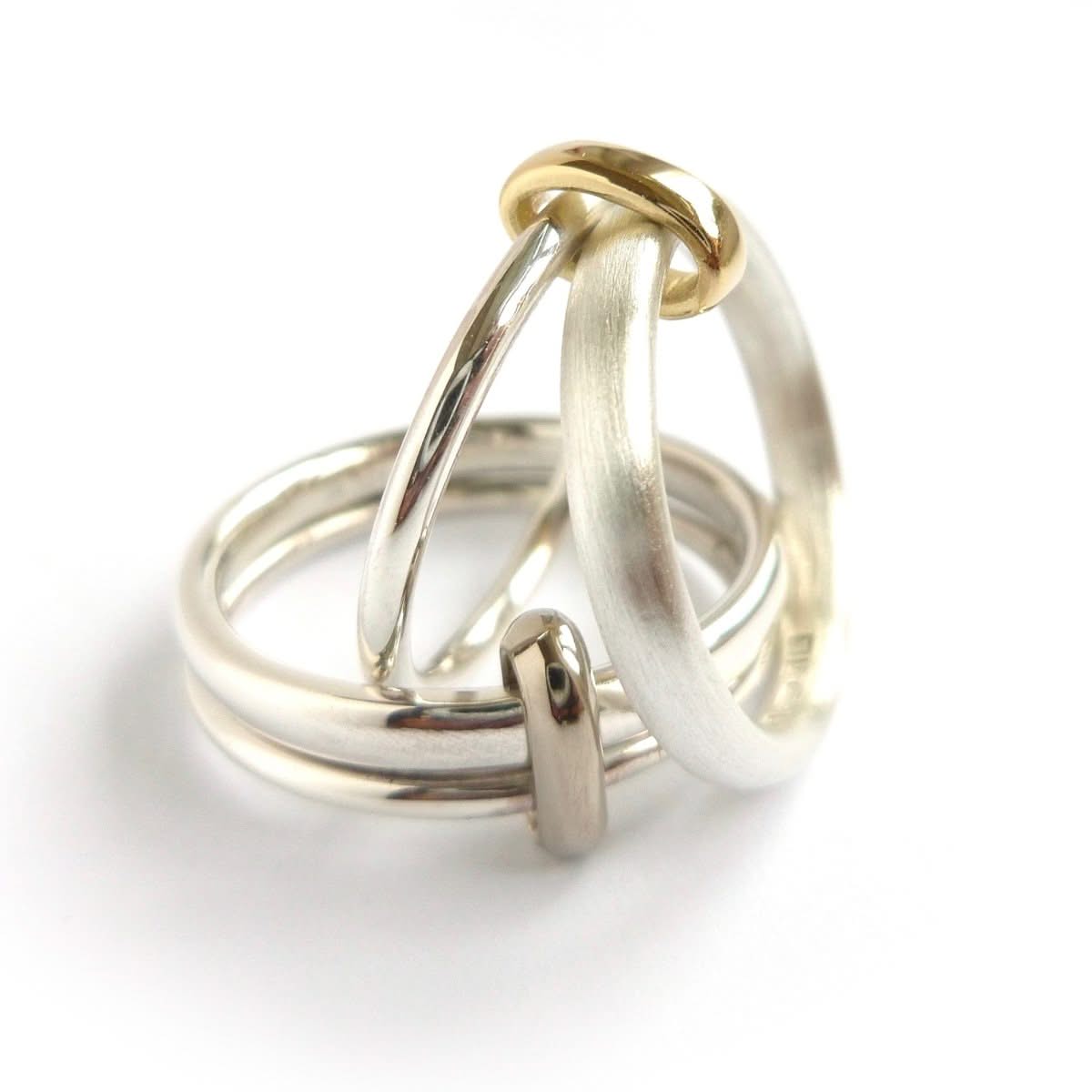 Detailed view of the silver double‑band ring with subtle movement and contrasting 18ct gold loop