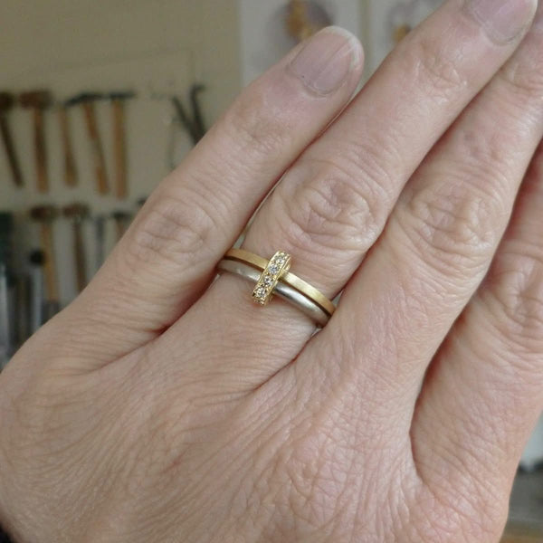 Modern and bespoke two band two tone ring with pave set diamonds. Modern, unique two band ring joined together with diamonds. An alternative eternity or wedding ring. Multi band ring or interlocking ring, sometimes called double band ring too.
