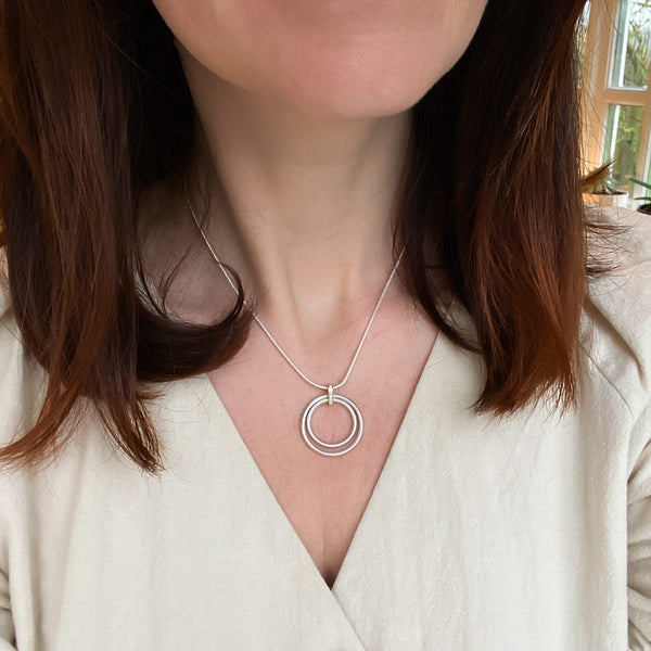 Model wearing the 28mm Sue Lane pavé diamond and silver necklace on a snake chain.