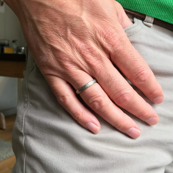 Contemporary, modern and bespoke hammered white gold wedding ring by designer maker Sue Lane Jewellery. Perfect wedding ring for men or women.