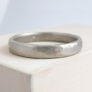 Contemporary, modern and bespoke hammered white gold wedding ring by designer maker Sue Lane Jewellery. Perfect wedding ring for men or women.