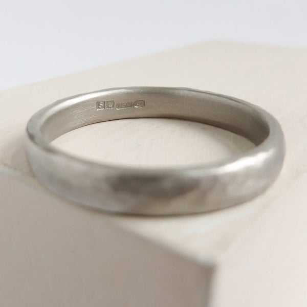 Contemporary, modern and bespoke hammered white gold wedding ring by designer maker Sue Lane Jewellery. Perfect wedding ring for men or women.