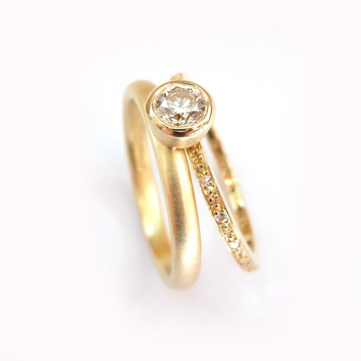 Modern two band diamond ring alternative modern engagement ring Sue Lane. Multi band ring or interlocking ring, sometimes called double band ring too.