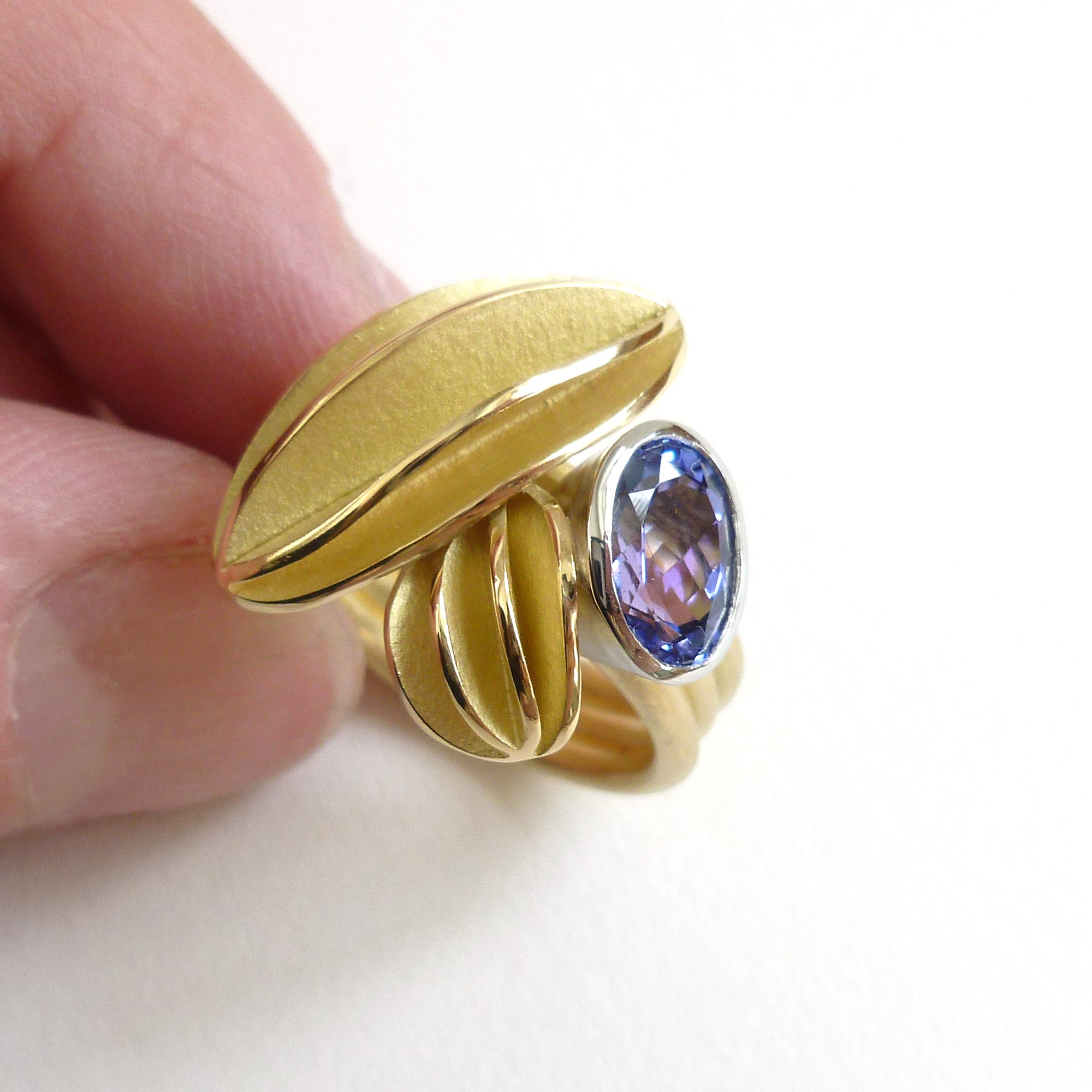 Unique contemporary gold, platinum and tanzanite ring with gold leaf shape detail