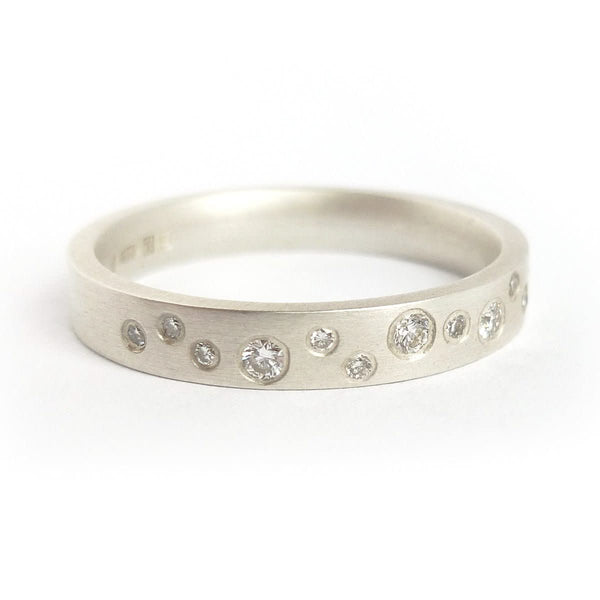 Handmade modern silver eternity ring with flush set diamonds by Sue Lane