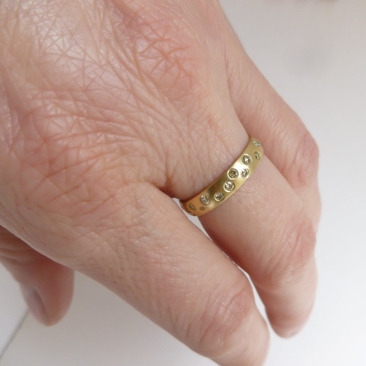 A modern, contemporary gold eternity ring, wedding ring, or engagement ring by Sue Lane