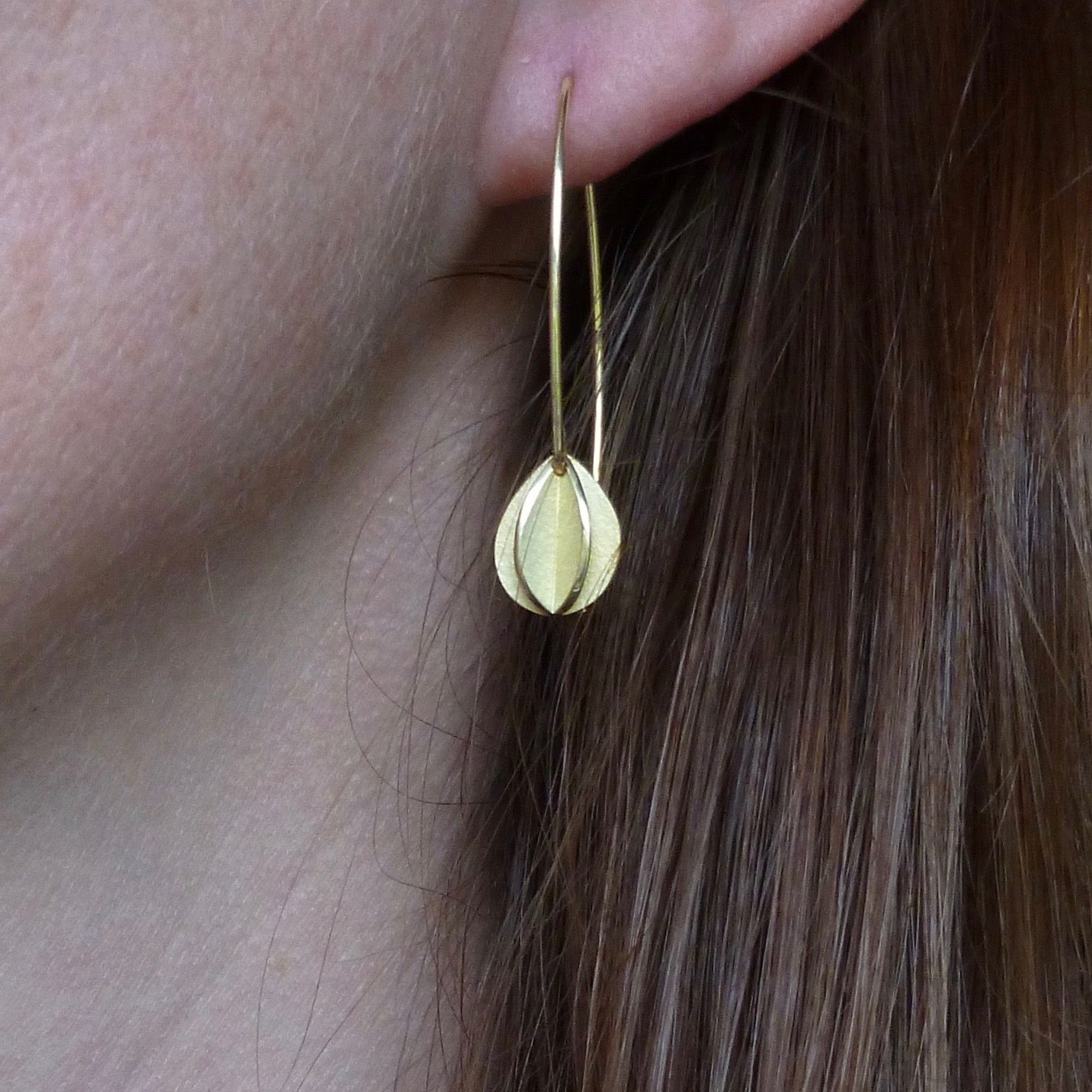 Contemporary modern bespoke leaf hook earrings in yellow gold handmade with a brushed finish
