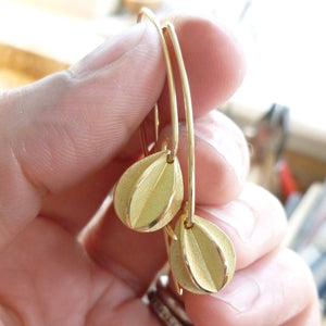 Modern unique leaf hook earrings in yellow gold handmade with a brushed finish