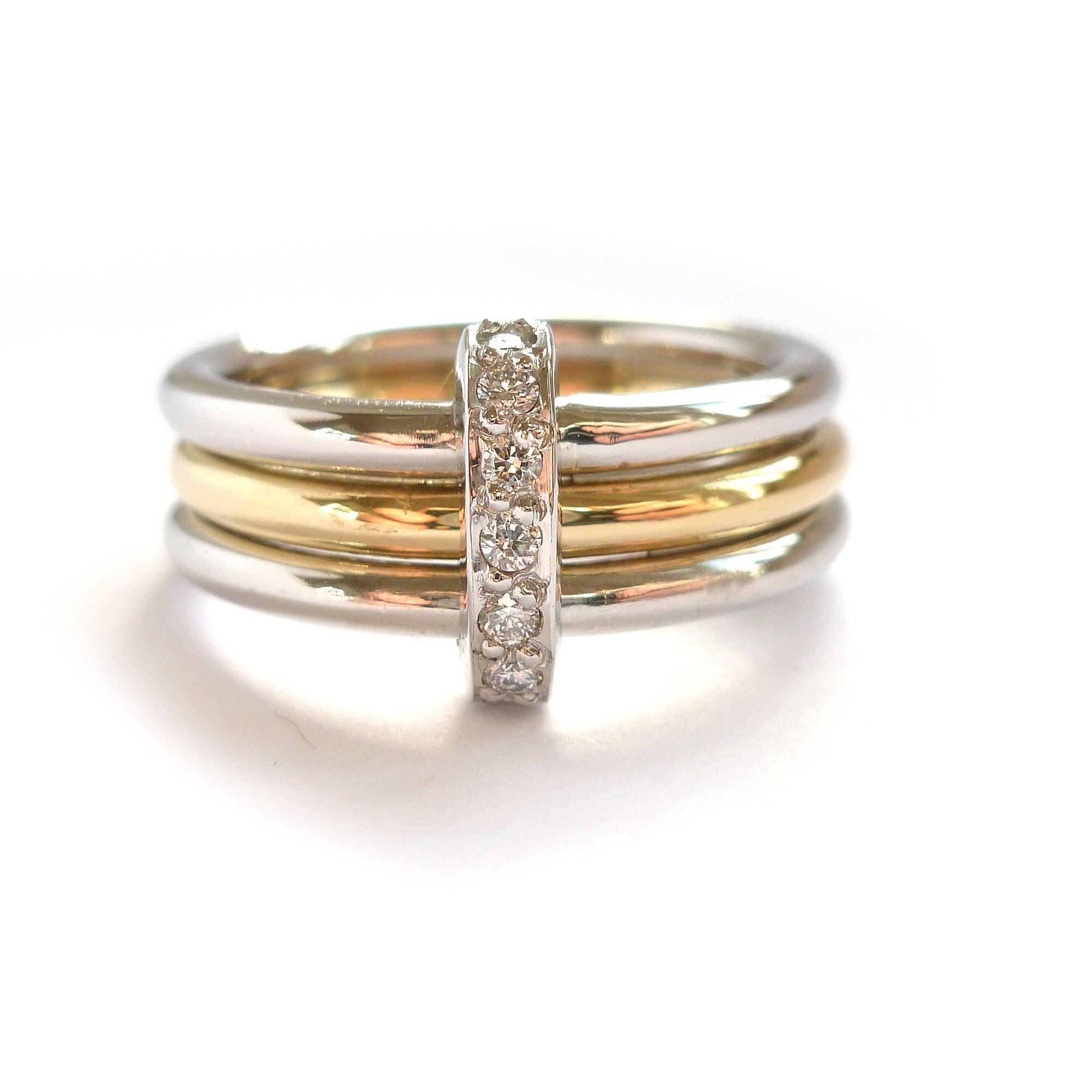 Modern two tone, platinum and yellow gold three band stacking ring with diamonds. Multi band ring or interlocking ring, sometimes called triple band rings too.