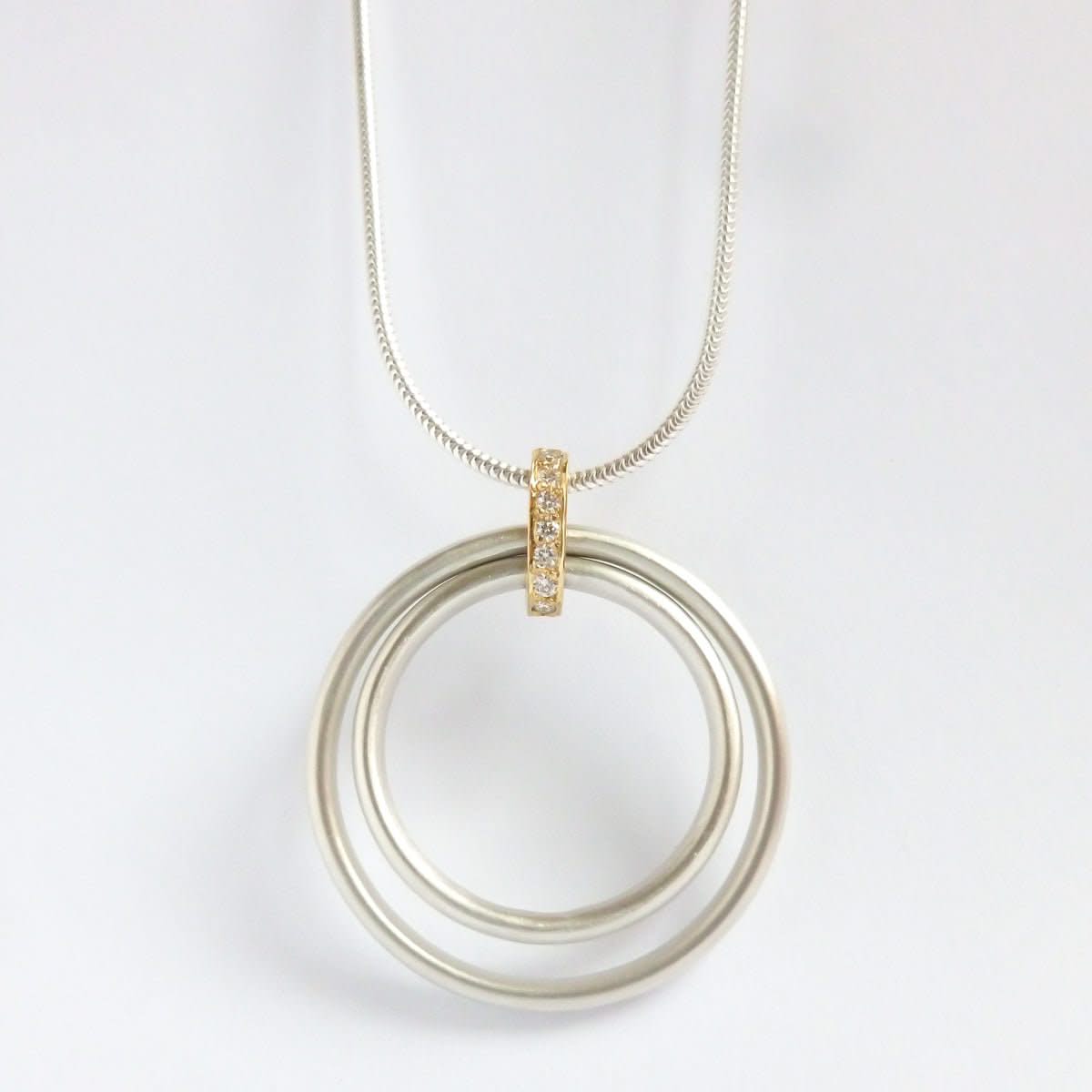 Handmade silver and 18ct gold necklace with a string of 7 pavé-set diamonds