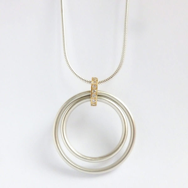 Handmade silver and 18ct gold necklace with a string of 7 pavé-set diamonds