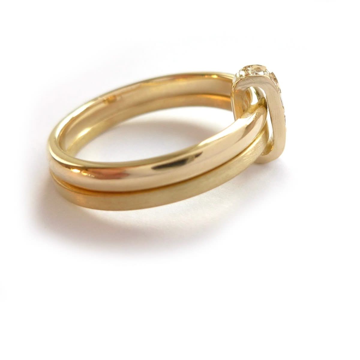 Modern two band ring joined together with a row of pave set diamonds, making a unique commitment ring or eternity ring. Multi band ring or interlocking ring, sometimes called double band ring too.