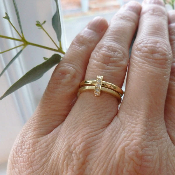 Modern two band ring joined together with a row of pave set diamonds, making a unique commitment ring or eternity ring. Multi band ring or interlocking ring, sometimes called double band ring too.