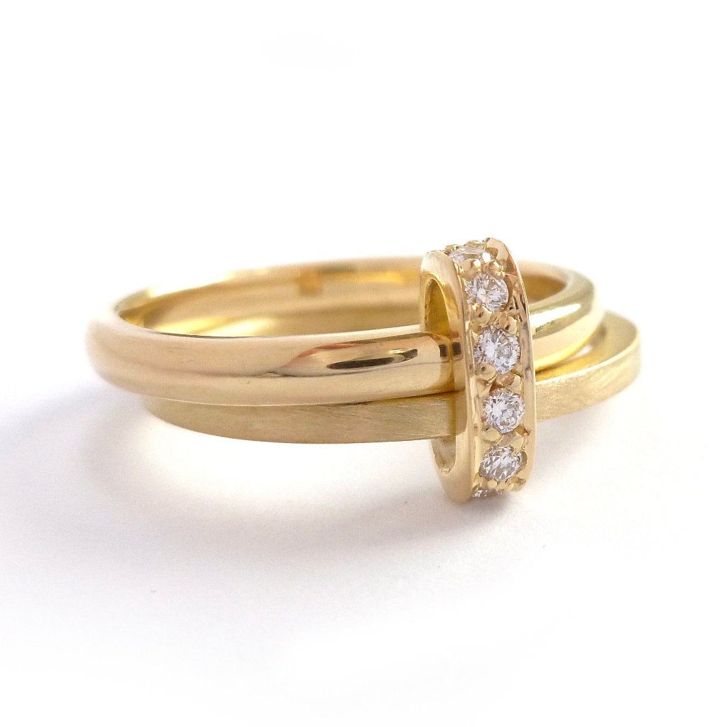 Modern two band ring joined together with a row of pave set diamonds, making a unique commitment ring or eternity ring   Multi band ring or interlocking ring, sometimes called double band ring too.