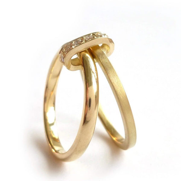 Modern two band ring joined together with a row of pave set diamonds, making a unique commitment ring or eternity ring. Multi band ring or interlocking ring, sometimes called double band ring too.