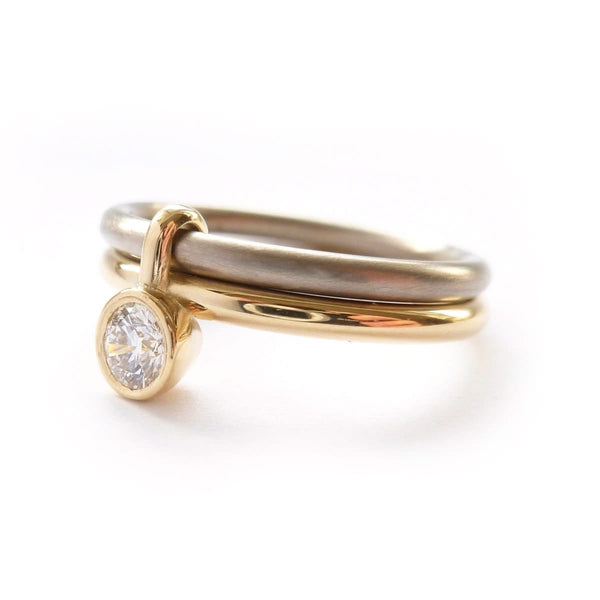 A unique modern contemporary 18ct gold two tone stacking engagement ring with white diamond. Multi band ring or interlocking ring, sometimes called double band ring too.