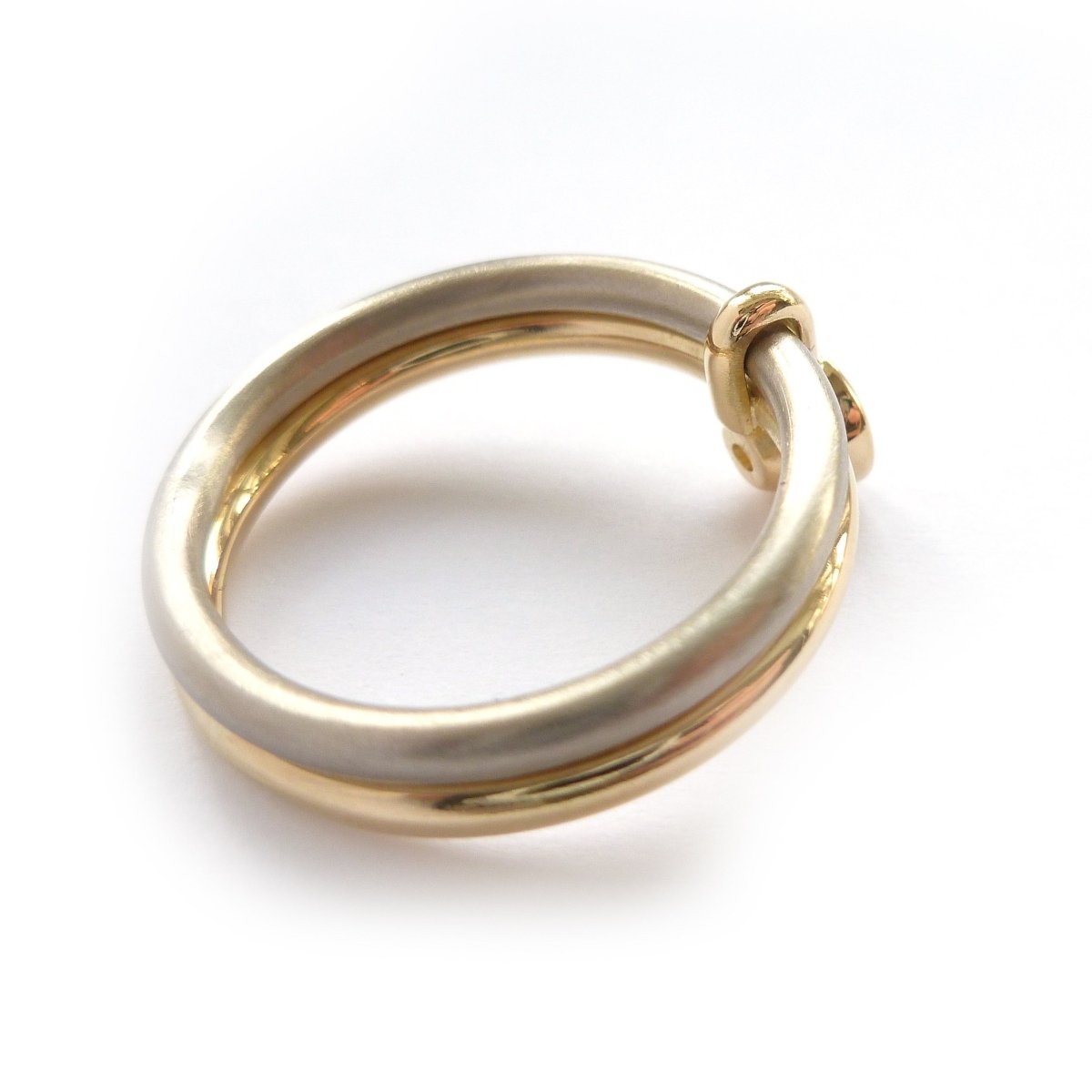 A unique modern contemporary 18ct gold two tone stacking engagement ring with white diamond. Multi band ring or interlocking ring, sometimes called double band ring too.