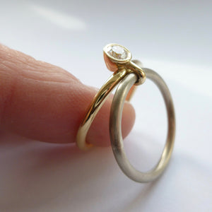 A unique modern contemporary 18ct gold two tone stacking engagement ring with white diamond. Multi band ring or interlocking ring, sometimes called double band ring too.