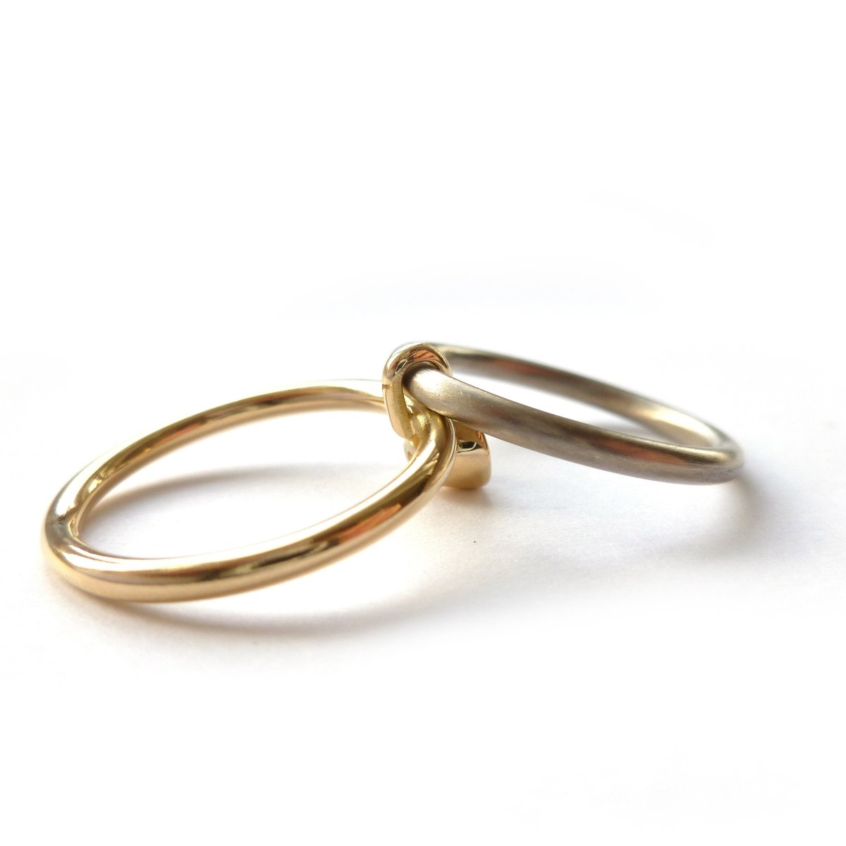 A unique modern contemporary 18ct gold two tone stacking engagement ring with white diamond. Multi band ring or interlocking ring, sometimes called double band ring too.