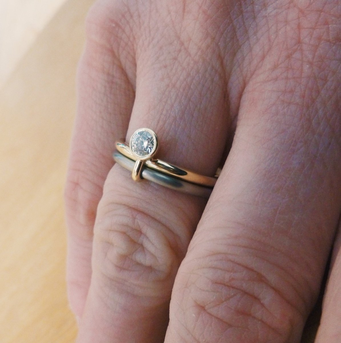 A unique modern contemporary 18ct gold two tone stacking engagement ring with white diamond. Multi band ring or interlocking ring, sometimes called double band ring too.