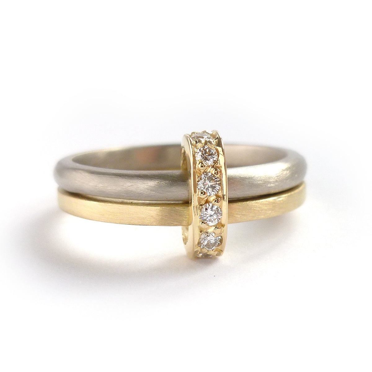 Modern and bespoke two band two tone ring with pave set diamonds. Modern, unique two band ring joined together with diamonds. An alternative eternity or wedding ring. Multi band ring or interlocking ring, sometimes called double band ring too.