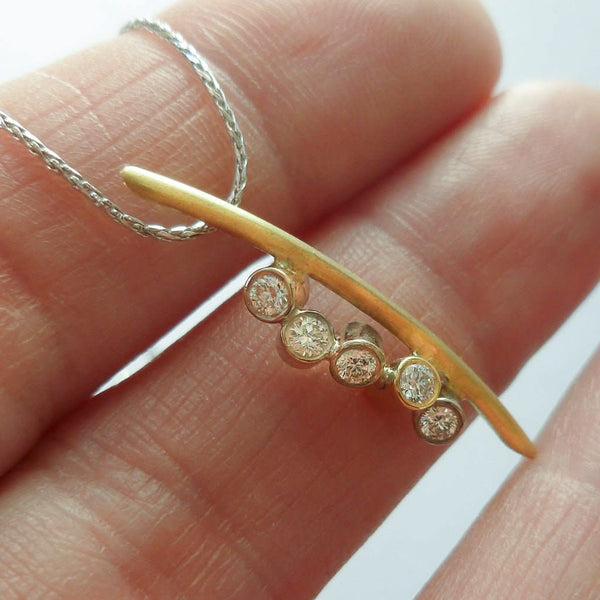 A modern two tone gold and diamond necklace / pendant with a soft necklet