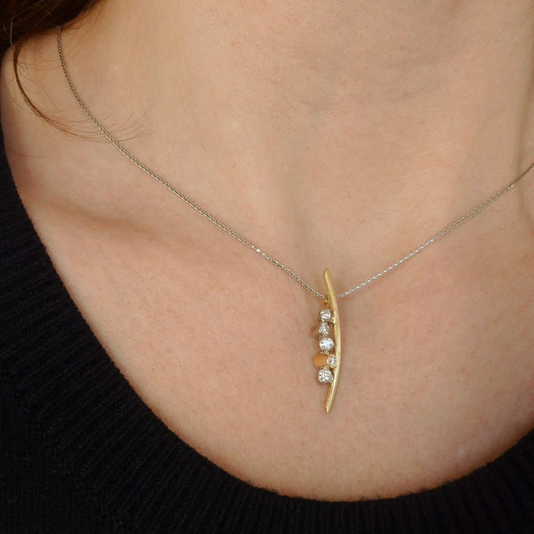 A modern two tone gold and diamond necklace / pendant with a soft necklet